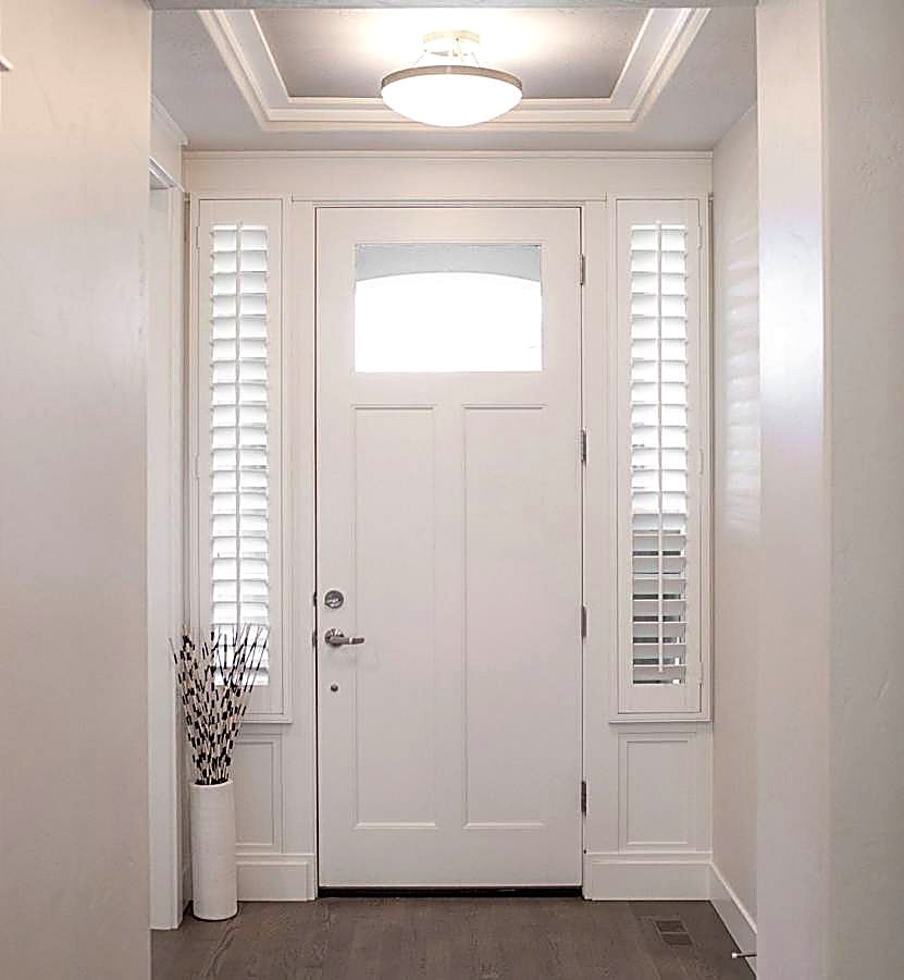 Sidelight plantation shutters flanking a front door
