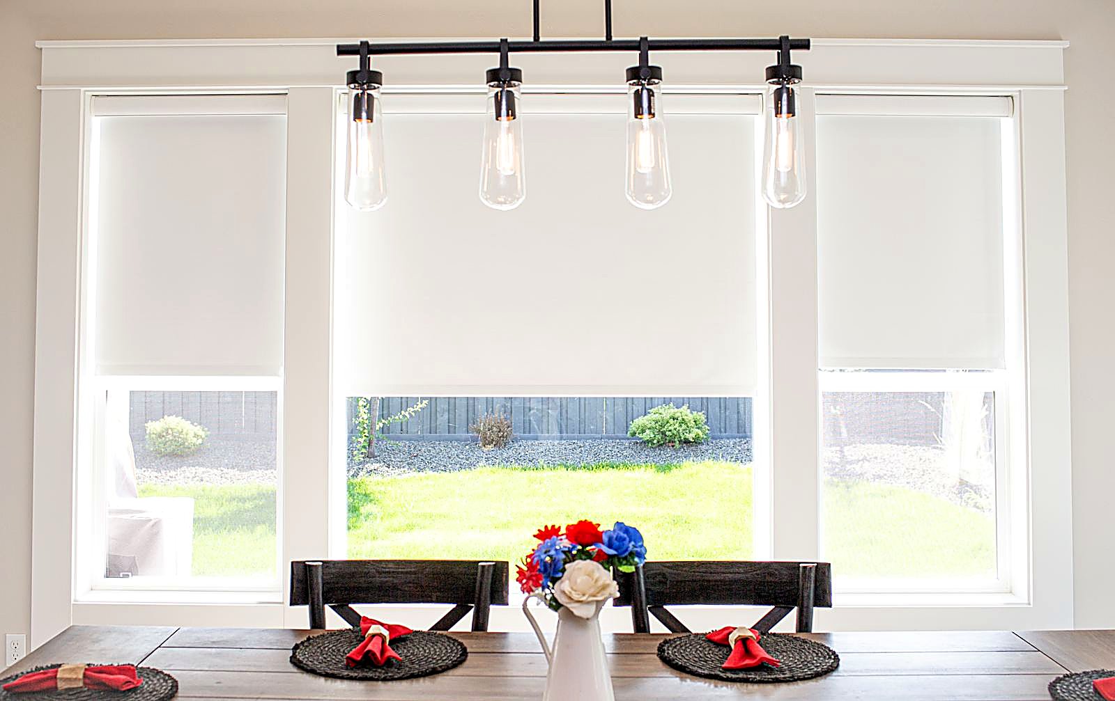 Custom roller shades over a dining room window