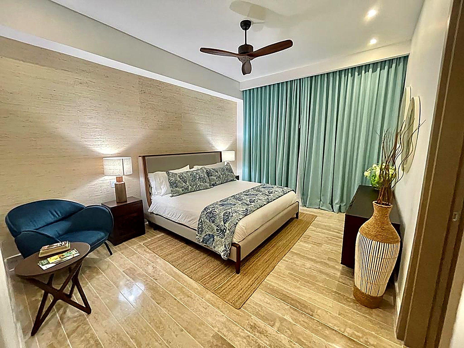Turquoise floor-to-ceiling curtains in a bedroom