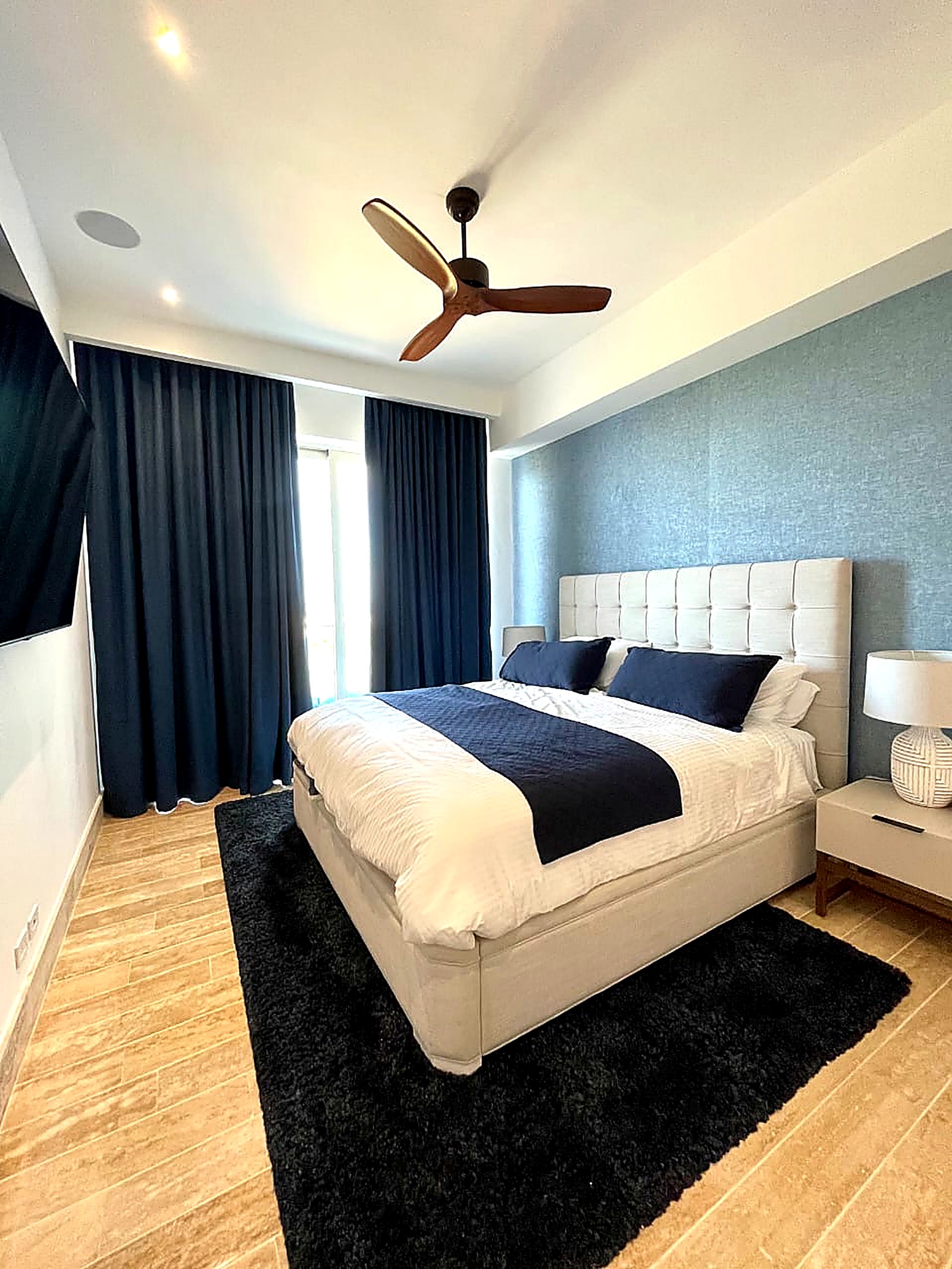 Custom navy curtains in a primary bedroom