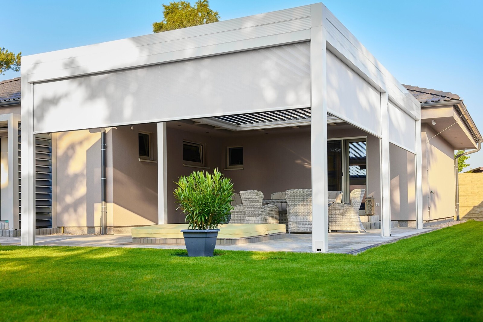 White retractable exterior sun shades on a covered patio